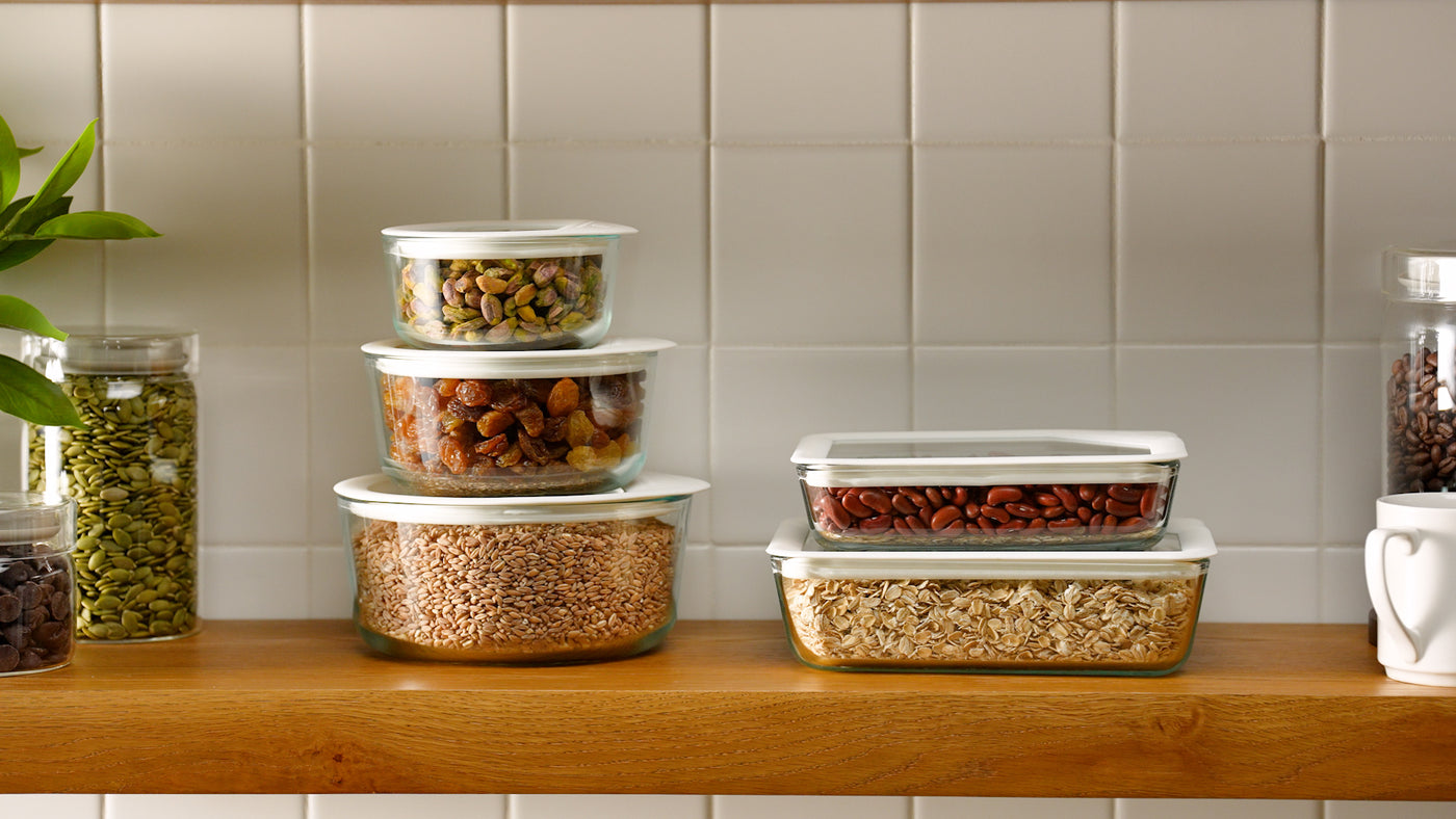 Set of food storage containers with lids on a kitchen counter