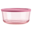 Pink food storage container with a lid on a white background