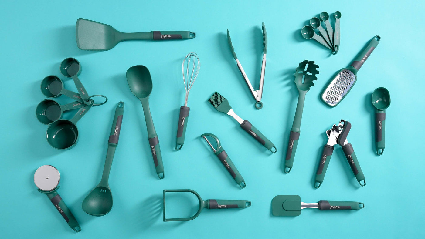 Set of green kitchen utensils on a blue background