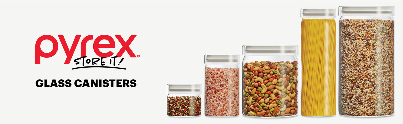 Pyrex glass canisters with food contents on a white background