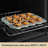 Silicone muffin tray with baked muffins in an oven, preheated up to 450°F/232°C.