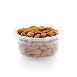 Clear plastic container filled with almonds on a white background