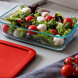 Glass container with salad on a white surface