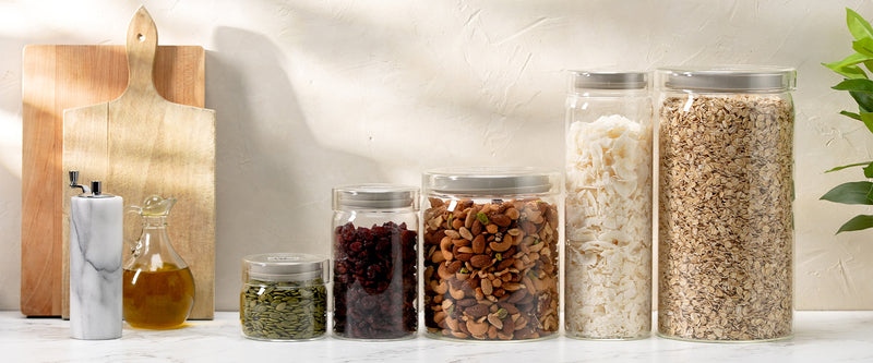 Set of glass jars with various contents on a kitchen counter